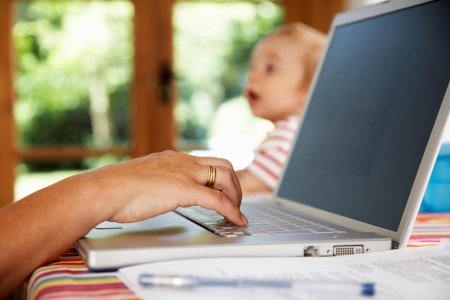 Mother with Baby Boy Using Laptop