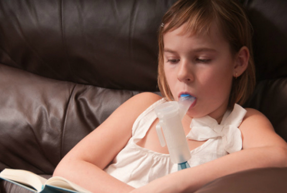 Child taking antibiotic inhaler