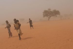 People walking through a sandstorm in Niger