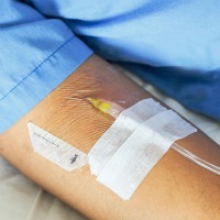 IV needle on patient arm 