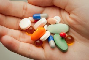 Photo of hand holding pills