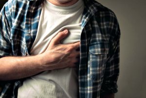 Man clutching heart