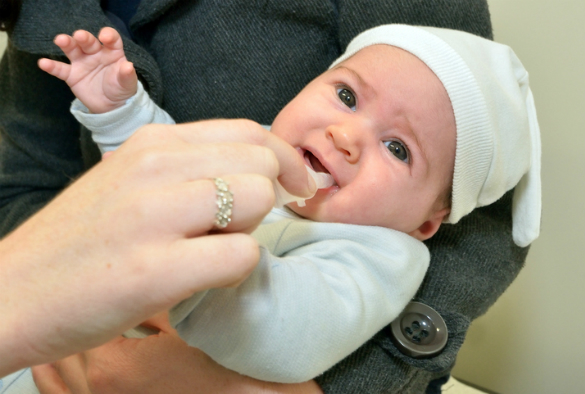 a baby being given an oral rotavirus vaccine