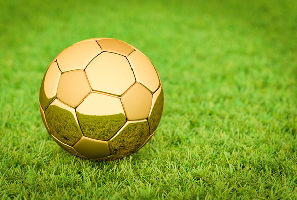 3D rendering: Golden Soccer ball / football lying on grass in a stadium, Big Business in sports, football, soccer.