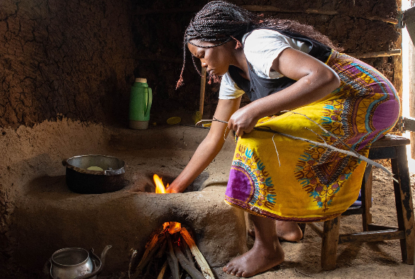 Women cooking over a traditional stove