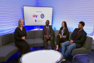 Two scholarship holders, their teacher and a TV presenter sat on a sofa