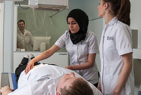 Three health sciences students working in simulation suite