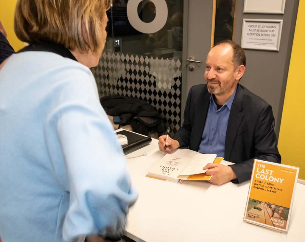 Philippe Sands signing a copy of his book