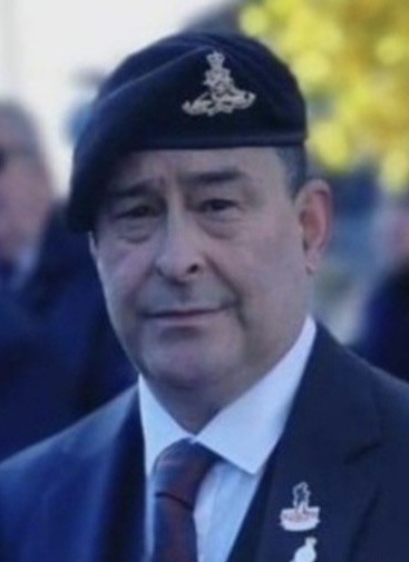 Phil Hurworth wearing a beret and medals at a Remembrance Sunday event