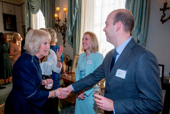 Dr Dan Hawcutt shaking hands with Her Majesty the Queen Consort at the event