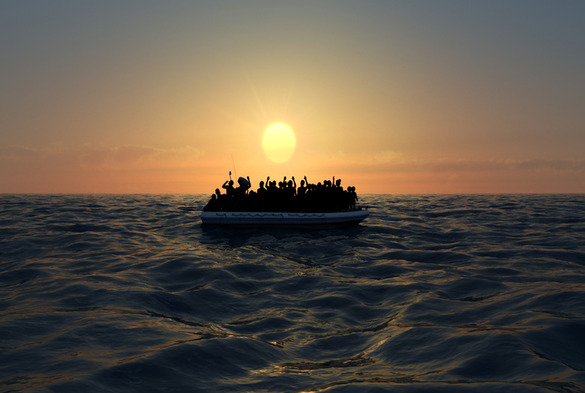A small boat on the sea carrying a lot of people
