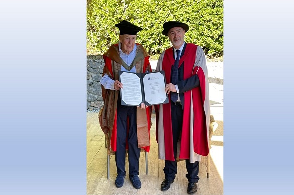 Photo of Peter Johnson being awarded honorary degree certificate by Professor Gavin Brown