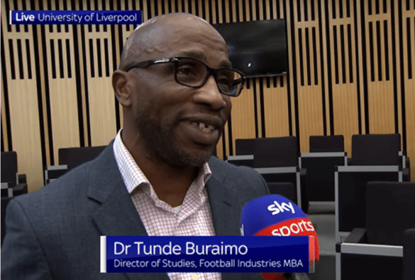 Dr Tunde Buraimo speaking into a microphone
