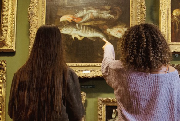Young people look at art in a gallery