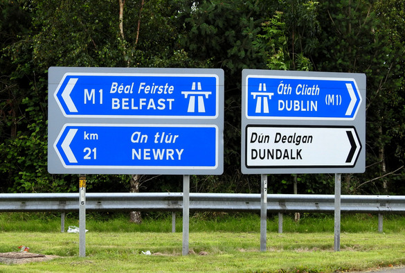 A picture of two road sings, one reading Belfast and one reading Dublin