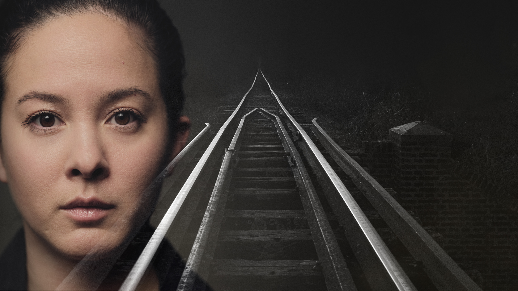 A face of a woman next to a train track