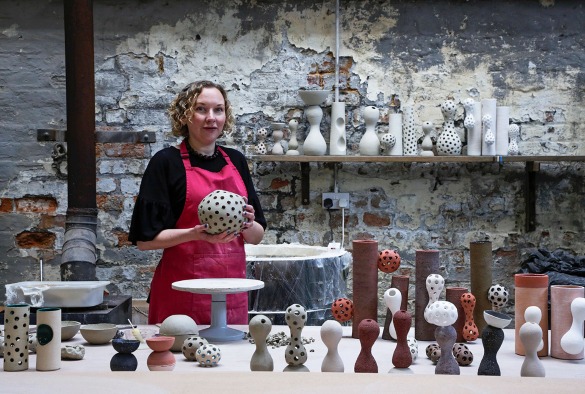 Artist Louise Waller stands with her work