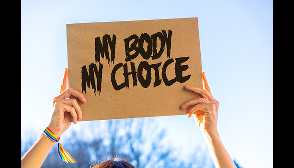 A perdon holding up an image at a pro choice demonstration