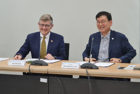 Professor Iain Buchan and Dr. Kim Hyung Kyun sitting at desk