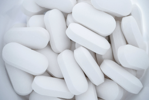 Medicine bottle filled with white tablets