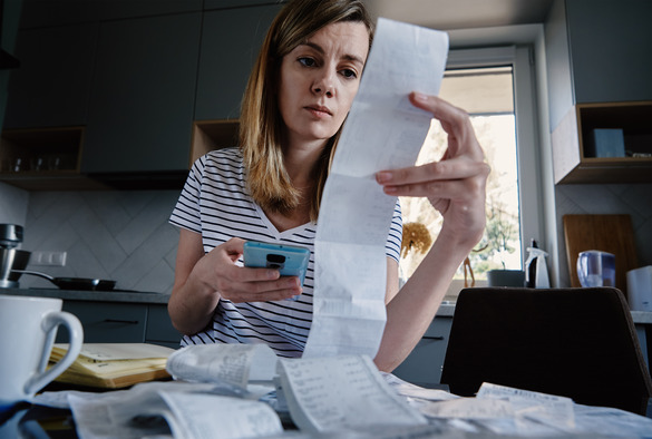 Woman calculating bills - GettyImages-1390794613