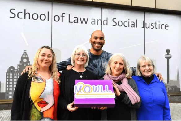 MOWLL staff standing in front of the School of Law and Social Justice
