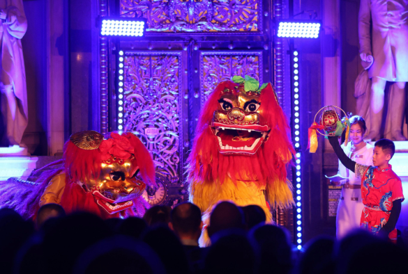 Two dancing Chinese New year dragons with the ornate door of St George's Hall as backdrop