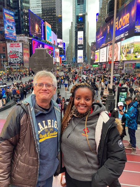 Two people stand in Times Square, New York 