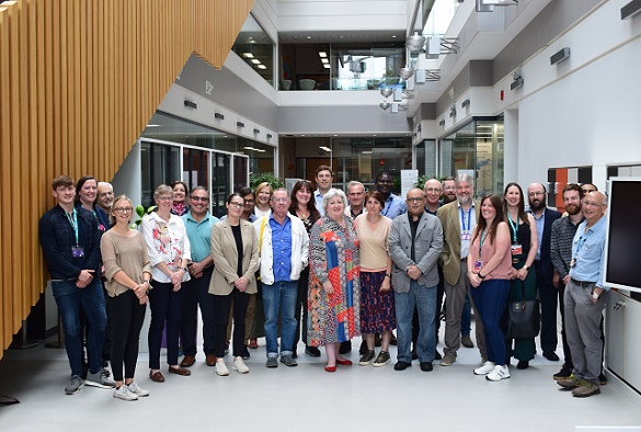 Group photo from Longevity consortium meeting - group stands in materials innovation factory foyer