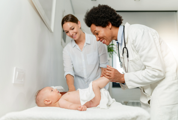 Female doctor pediatrician examining baby at clinic.
