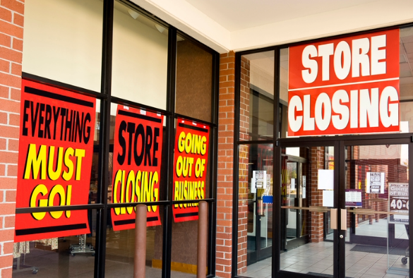 An image of a shop with red signs saying that its closing down and everything must go
