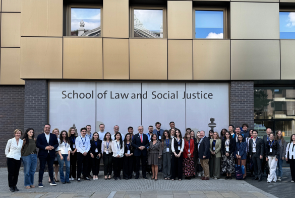 People standing outside the school of law and social justice building who attended the council or europe summer school