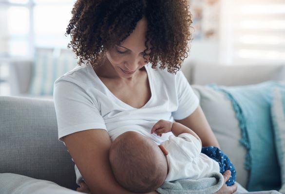 Women breast feeds baby