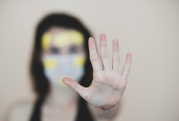 A woman putting her hand out in an image to represent domestic violence