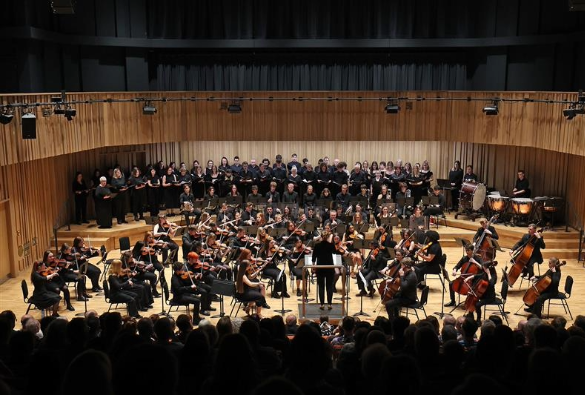 An orchestra playing at the Tung auditorium