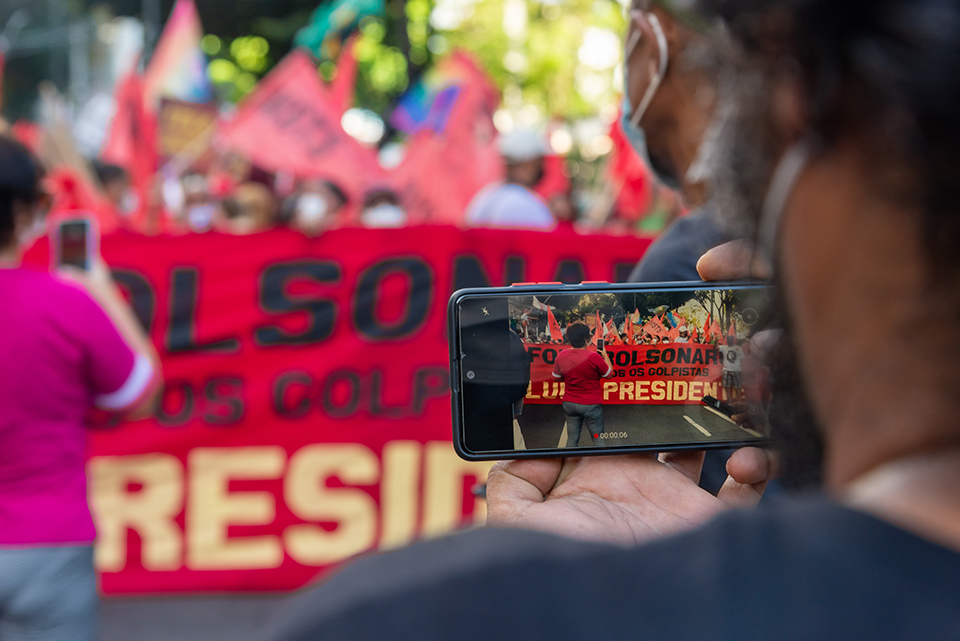 People protesting against far-right presidential candidate Jair Bolsonaro, with posters flags and banners