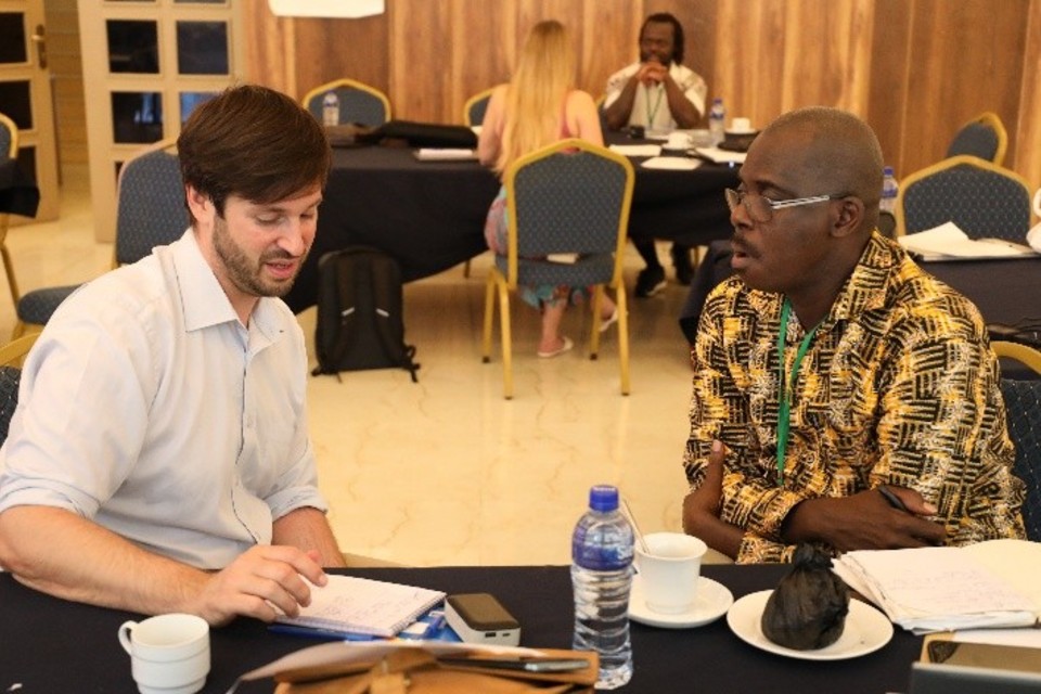 Derek Cocker with one of the Fellows, seated at table