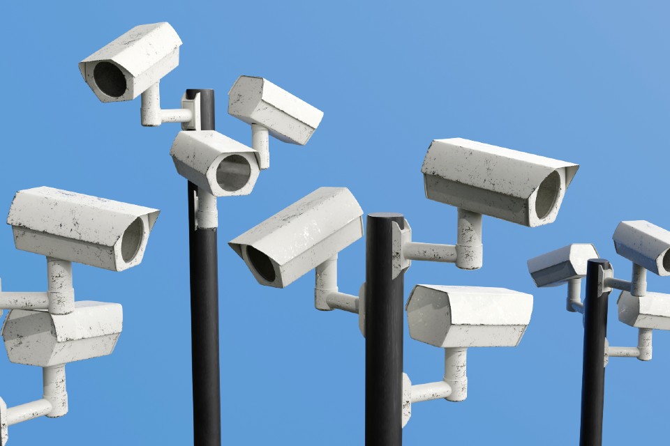Stock image - white cctv cameras against blue background