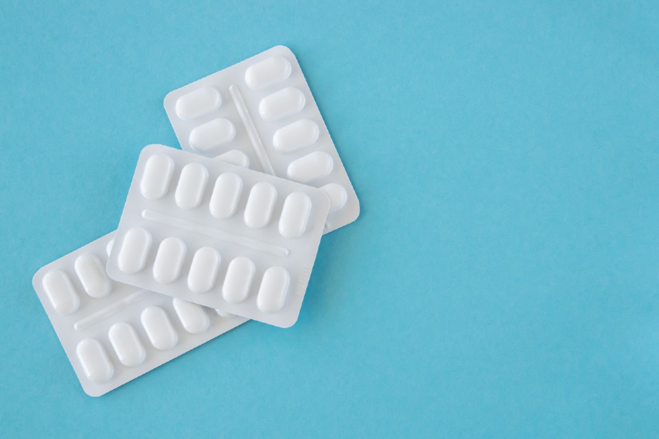 Paracetamol packets on a blue background