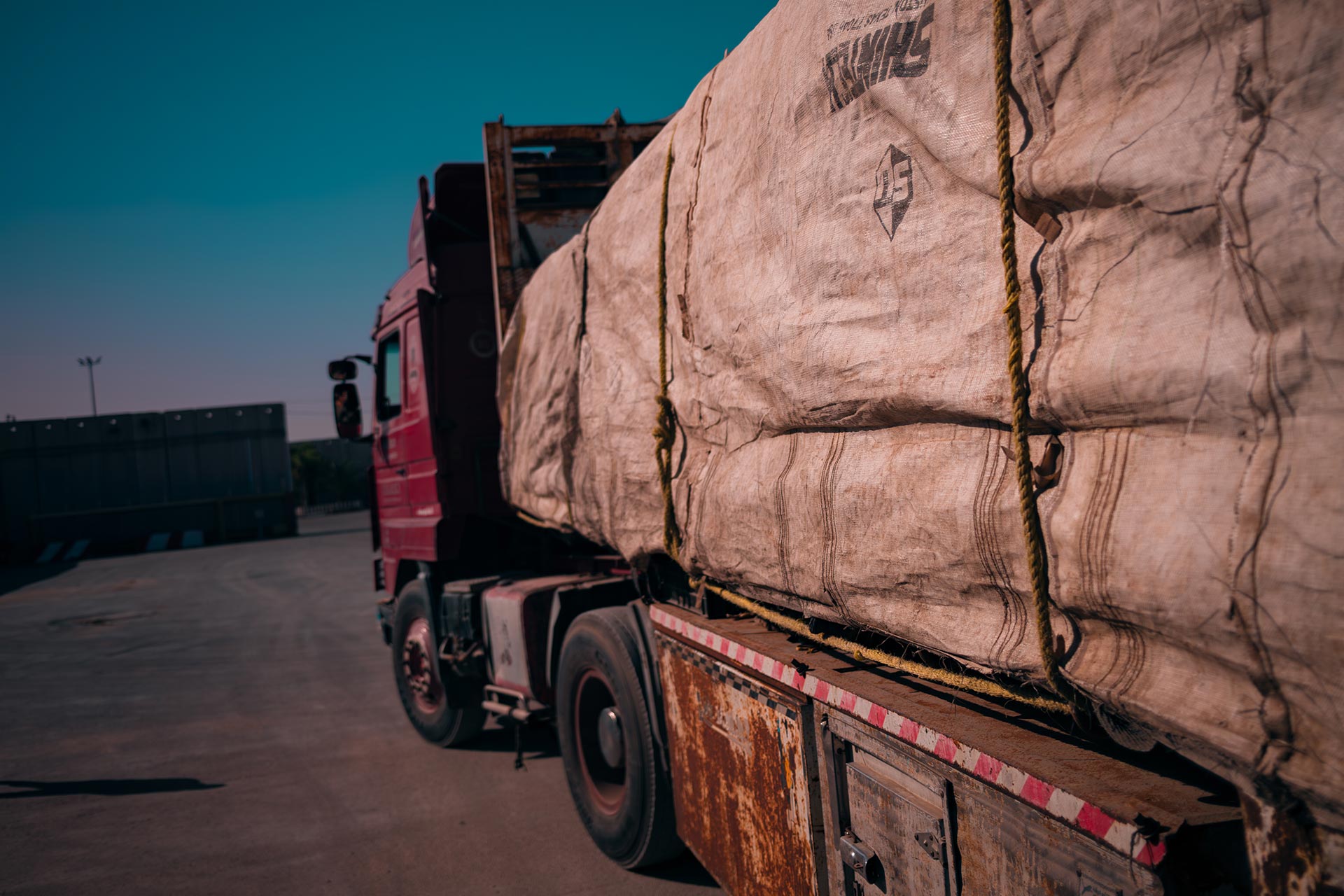 Kerem Shalom, Israel – January 10, 2024: A truck carrying large, canvas-covered humanitarian aid packages at the Israel-Gaza Kerem Shalom border crossing.