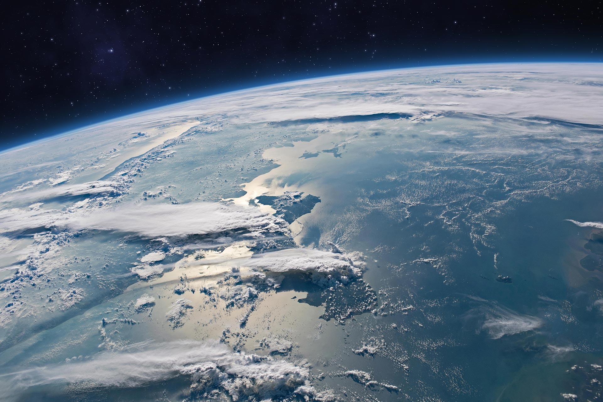 Blue planet Earth with ocean, clouds and continents in open space on the starry sky. Surface of planet Earth.