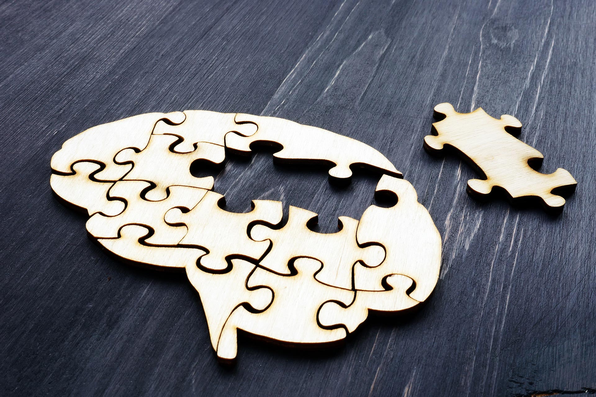 Brain from wooden puzzles. Mental Health and problems with memory. - stock photo
