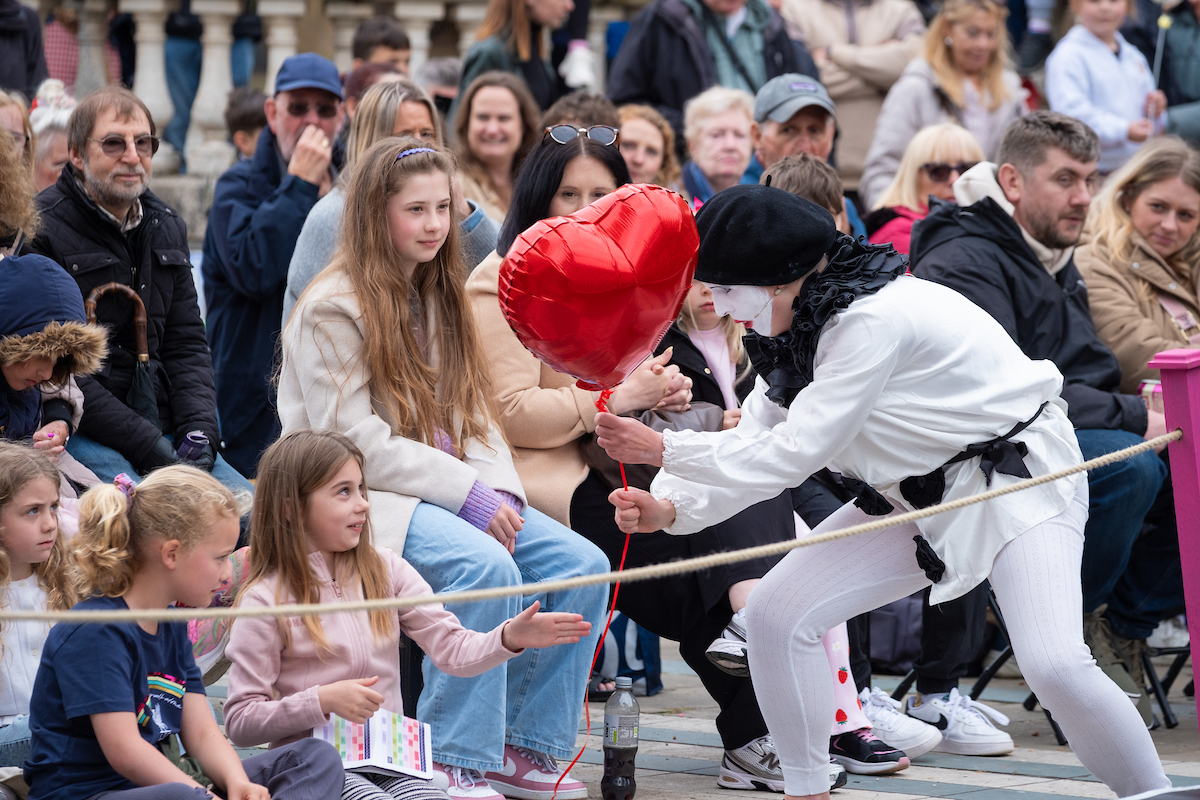 Dr Lybeck in clown costume interacts with audience in outdoor setting